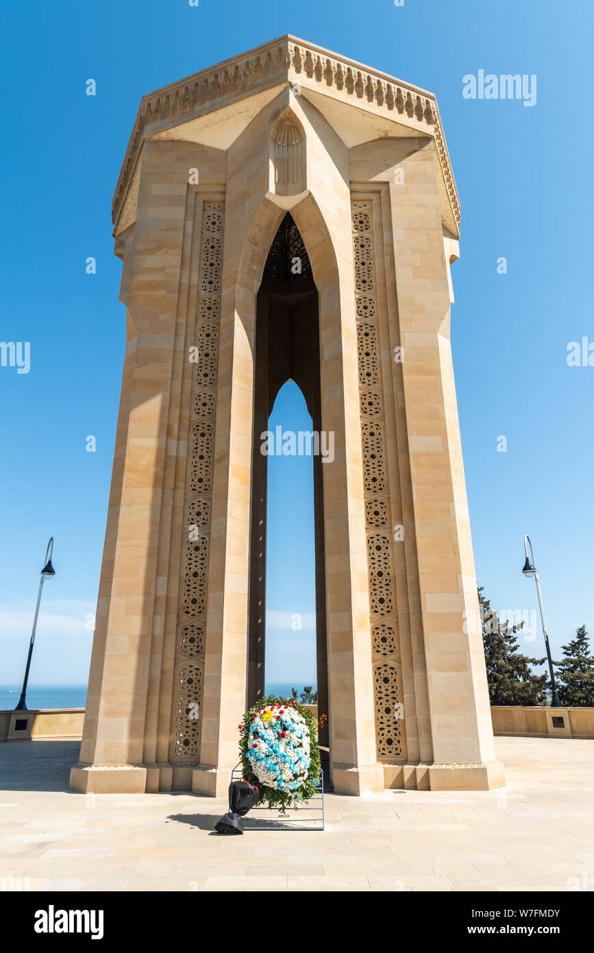 Baku, Azerbaijan - May 2, 2019. Eternal Flame Memorial, composed of a tomb standing on an 8-pointed star crown with a gold-framed glass dome, at the A Stock Photo