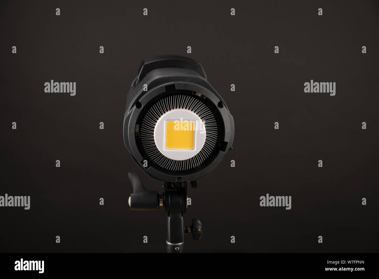 studio light flash lamp closeup on black background. View to matrix of