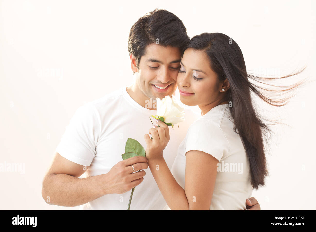 Young man giving a white rose to his girlfriend Stock Photo Alamy