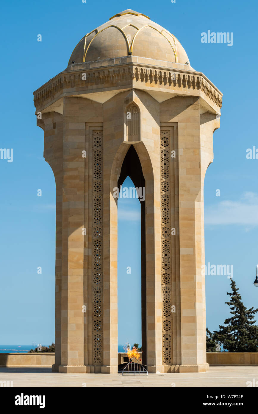 Baku, Azerbaijan - May 11, 2019. Eternal Flame Memorial, composed of a tomb standing on an 8-pointed star crown with a gold-framed glass dome, at the Stock Photo