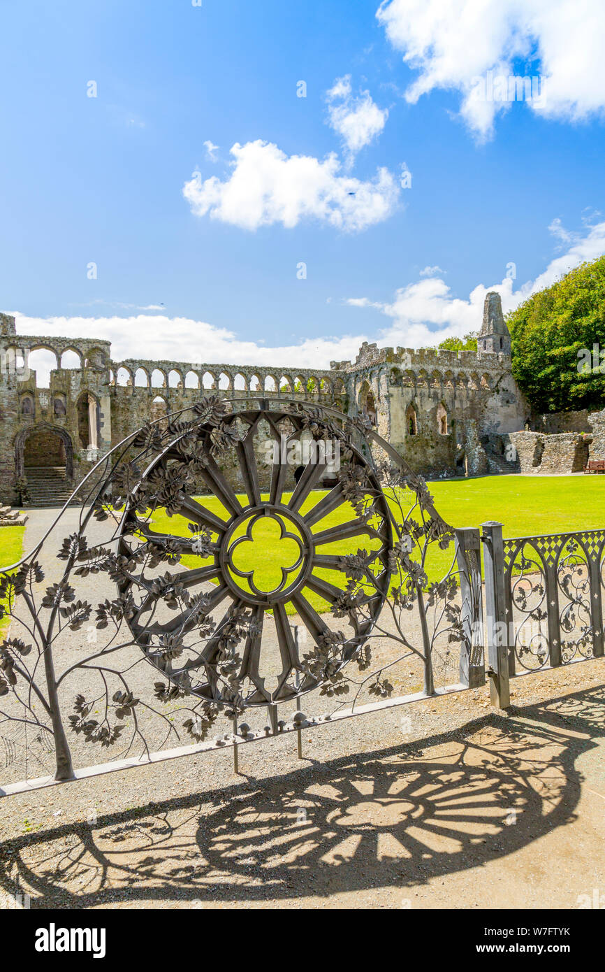 The intricate ironwork copy of the wheel window in the entrance gate to the historic 13th century Bishop's Palace, St Davids, Pembrokeshire, Wales, UK Stock Photo