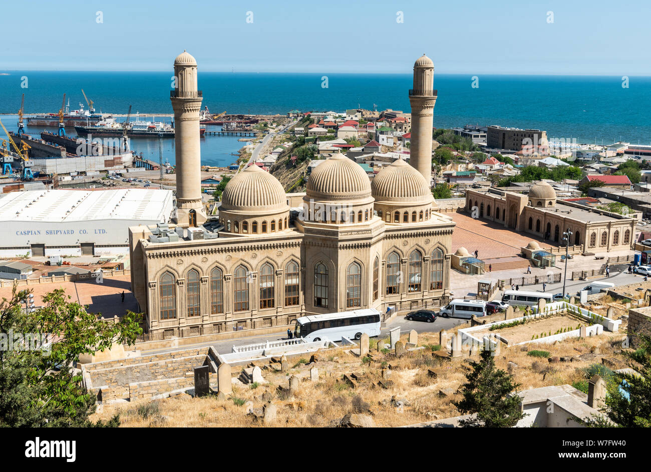 Bibi-Heybat, Baku, Azerbaijan - May 12, 2019. View over Bibi-Heybat mosque in Baku, with shipyard facilities, Caspian Sea and Bibi-Heybat settlement i Stock Photo