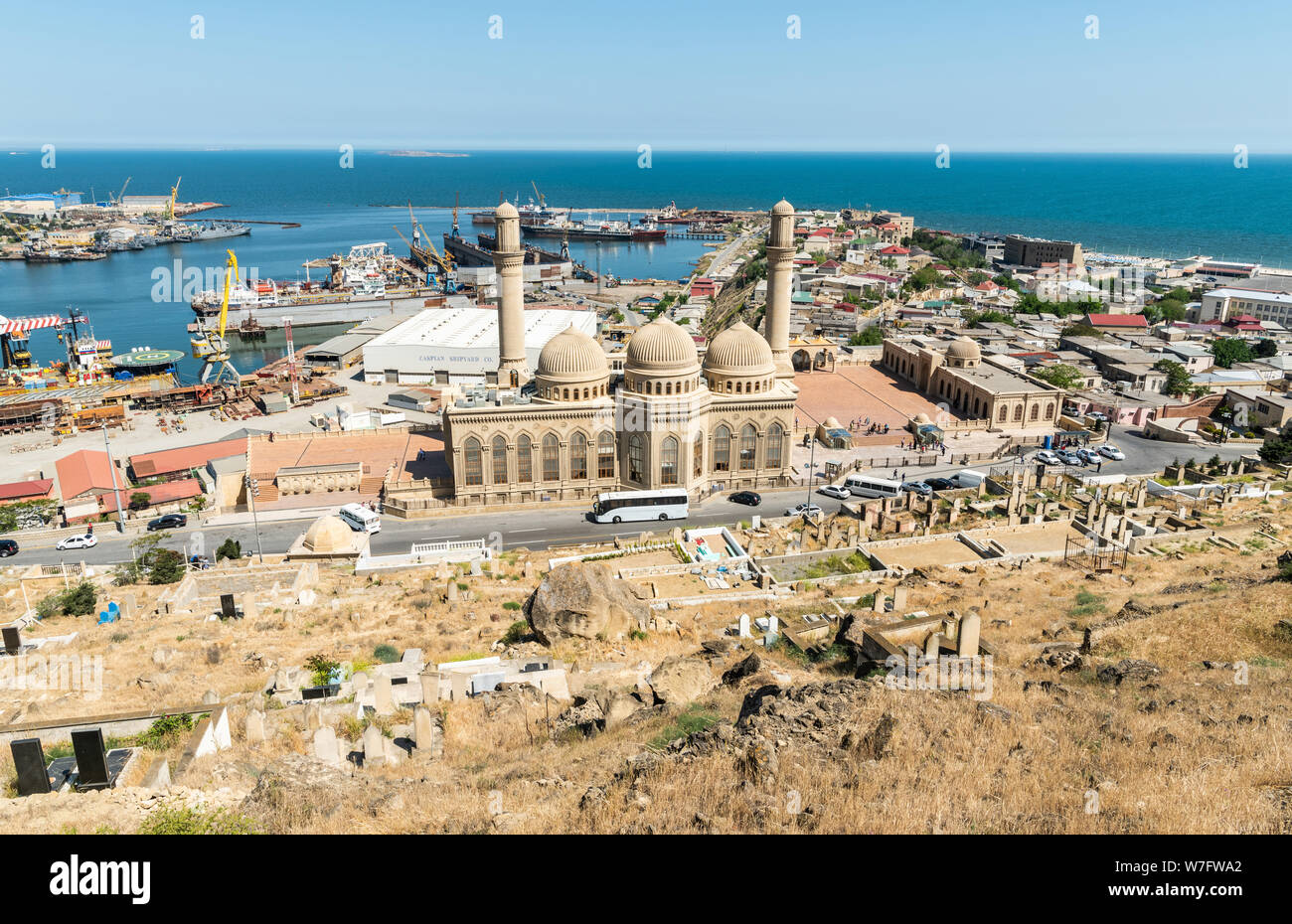 Bibi-Heybat, Baku, Azerbaijan - May 12, 2019. View over Bibi-Heybat mosque in Baku, with shipyard facilities, Caspian Sea and Bibi-Heybat settlement i Stock Photo