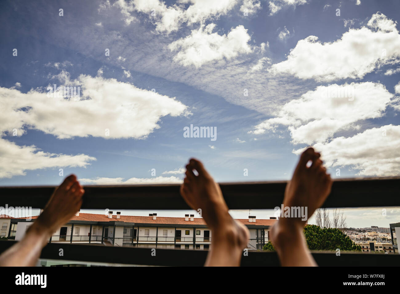 Resting On Railing People resting feet on railing with skies above Stock Photo - Alamy