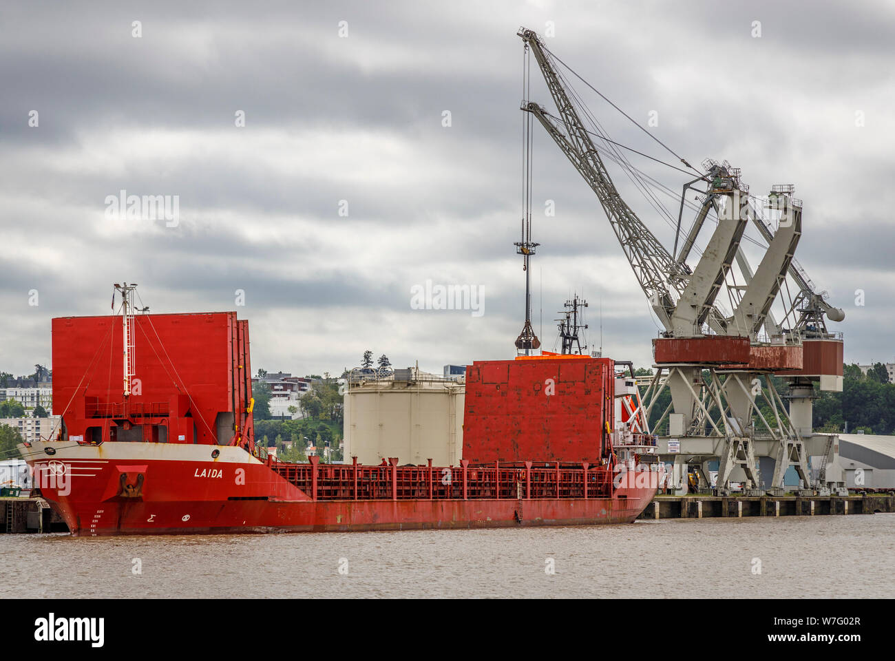Dockside gantry cranes is use in the wharfs beside the Garonne River, Bordeaux, France. 2003 general cargo ship Laida, under the Spanish flag. Stock Photo