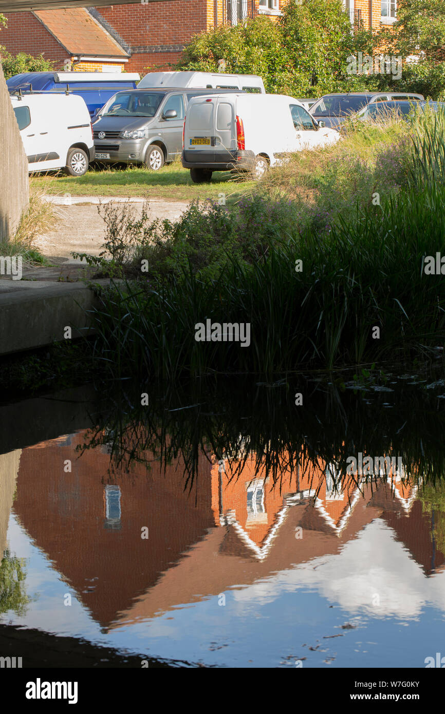 Reflections of houses in the Dorset Stour river in Gillingham North