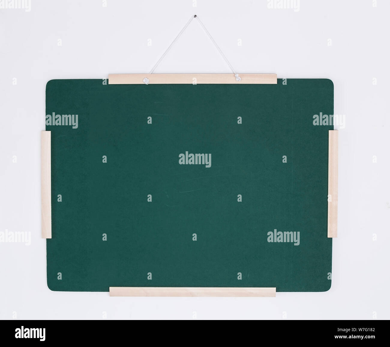 Green chalkboard hanging on white wall Stock Photo Alamy