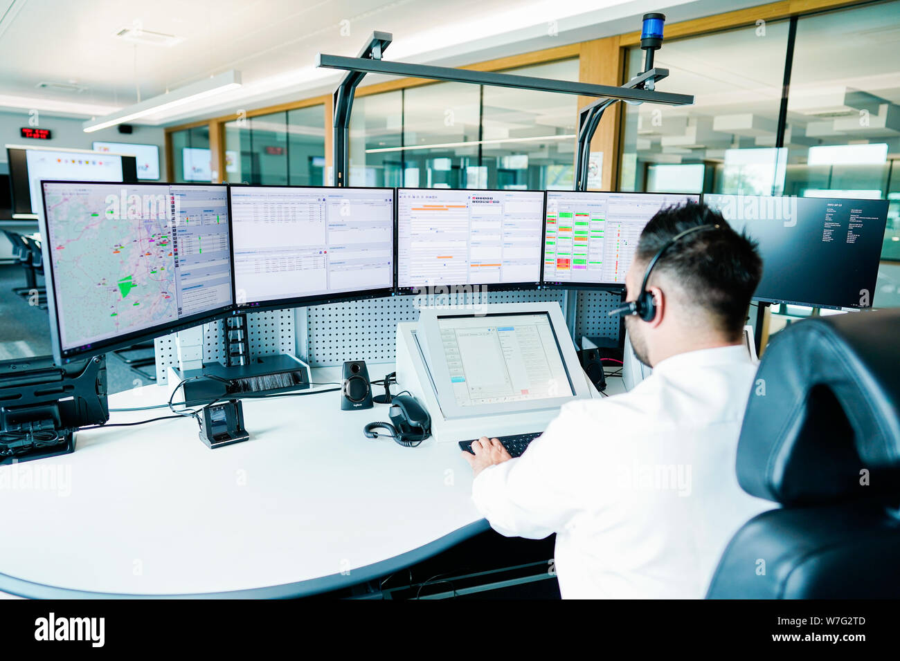 Ludwigshafen, Germany. 05th Aug, 2019. An employee sits at a control desk  in the integrated control center. During the "Im Land daheim-Tour" Dreyer  visits projects and institutions that deal with the future