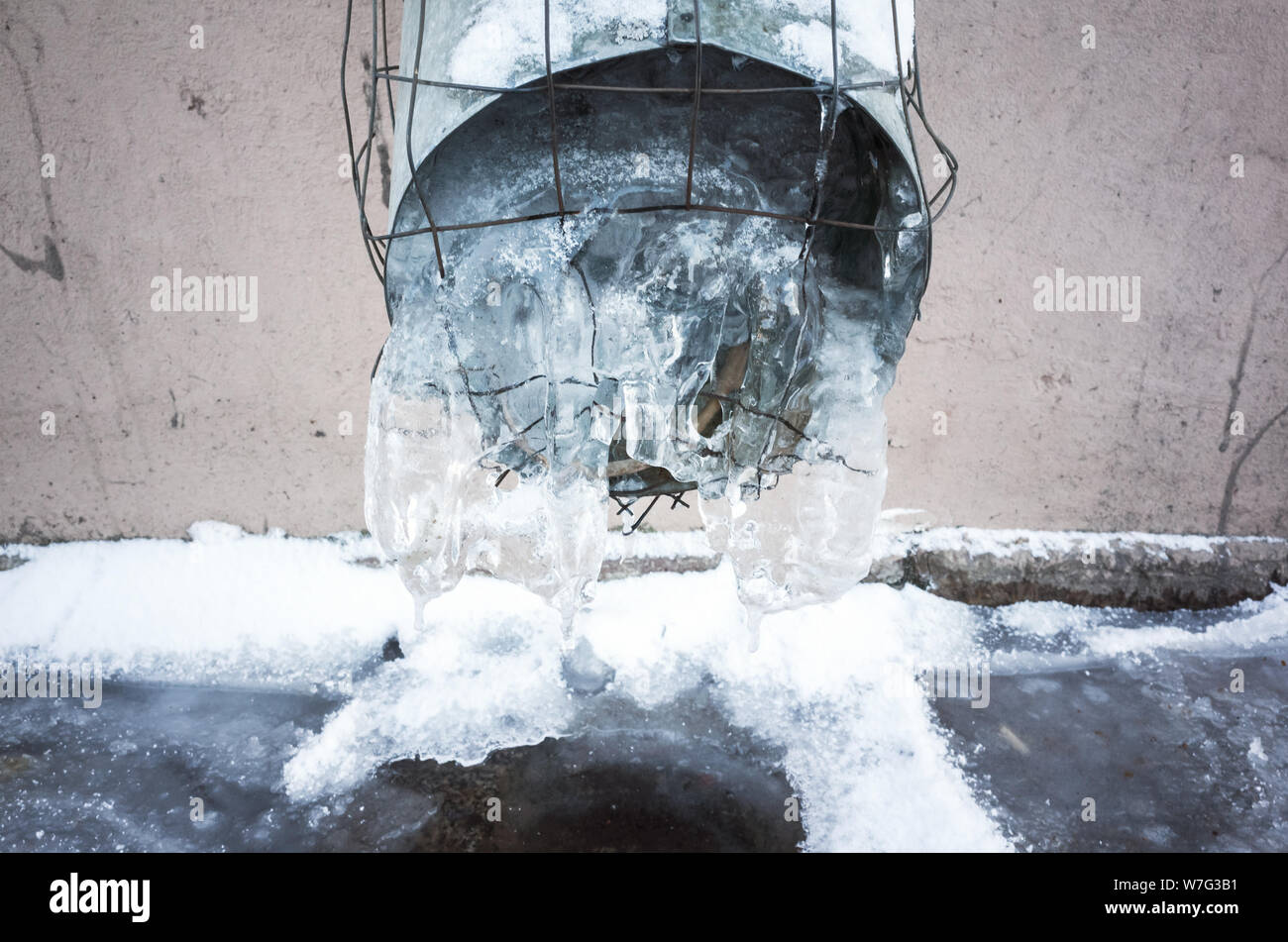 Frozen urban downspout full of ice. Winter in Saint-Petersburg, Russia Stock Photo