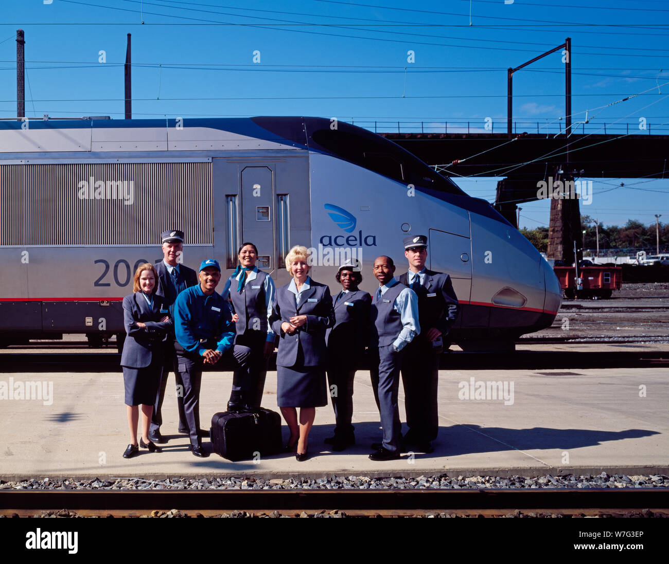 Amtrak employees show off their new uniforms in front of the brand new