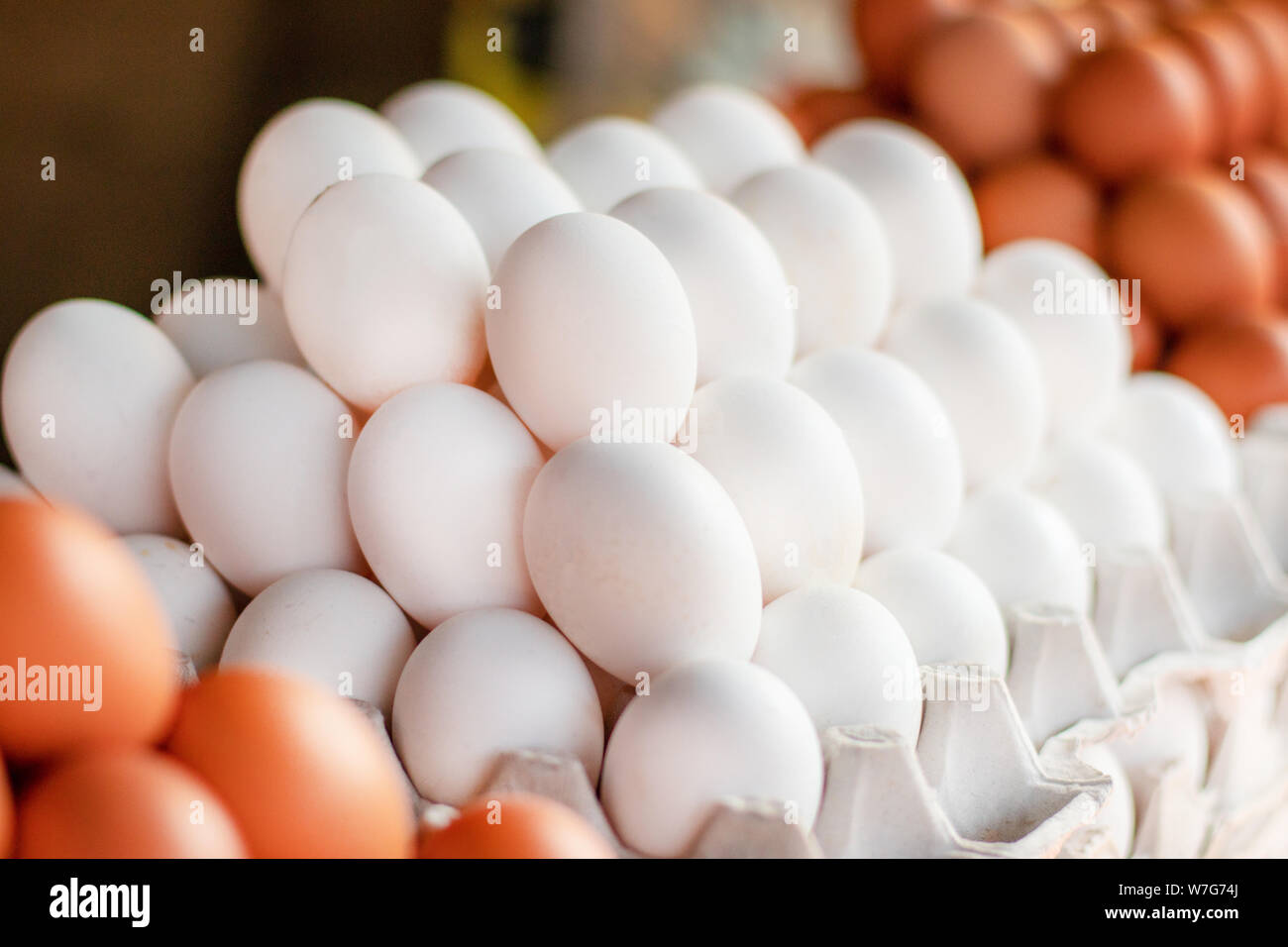 Fresh chicken eggs at a local farmers market. Assorted different size
