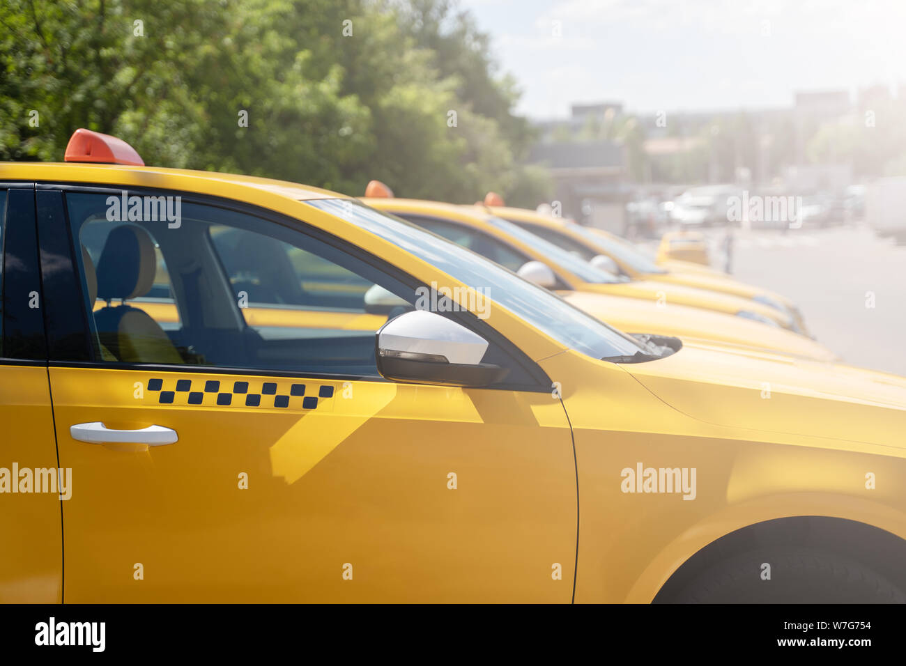 Image of yellow taxi on street in summer Stock Photo