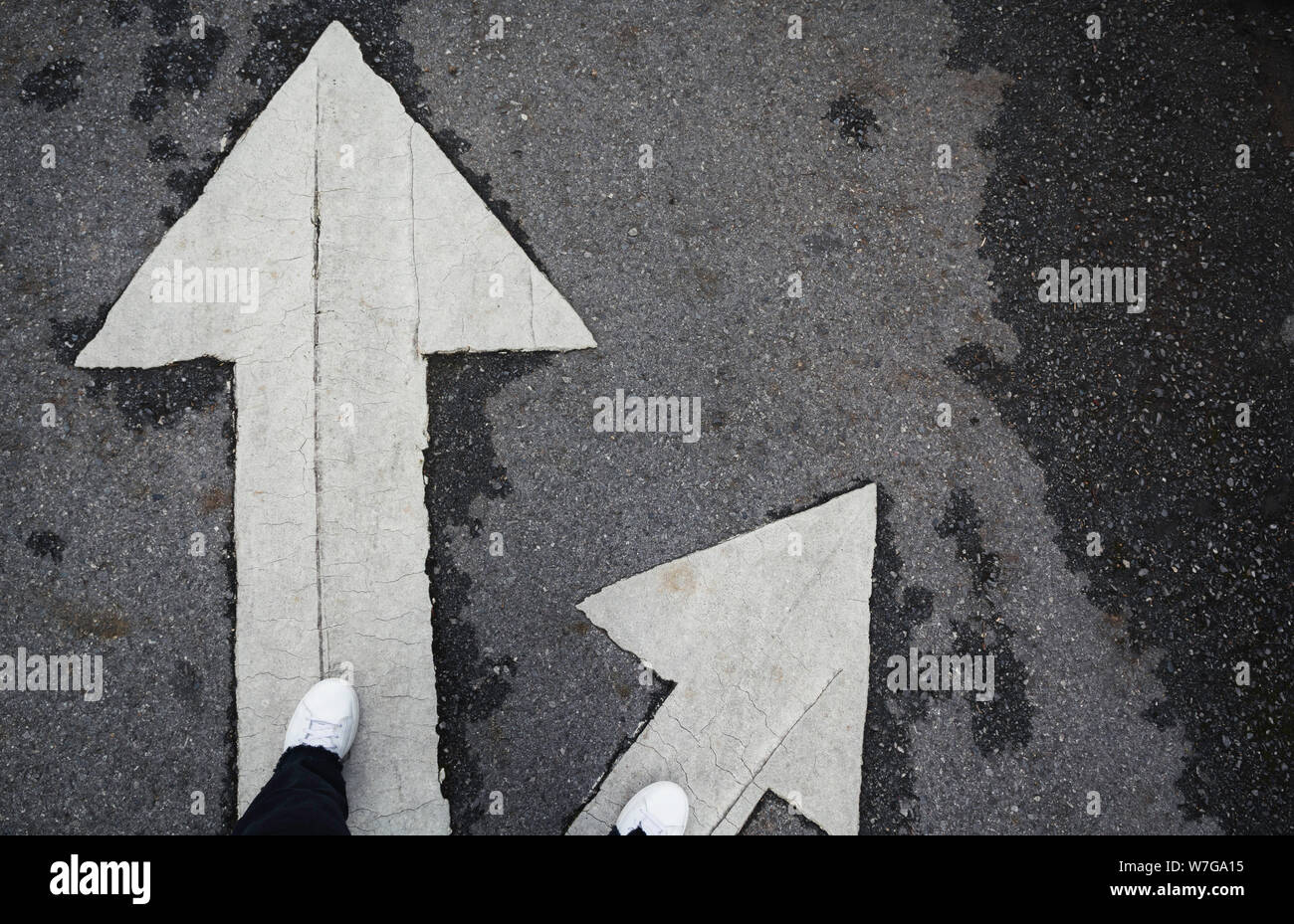 People standing at the crossroad and get to decision which way to go with copy space for insert text. Two ways to choose concept. Stock Photo