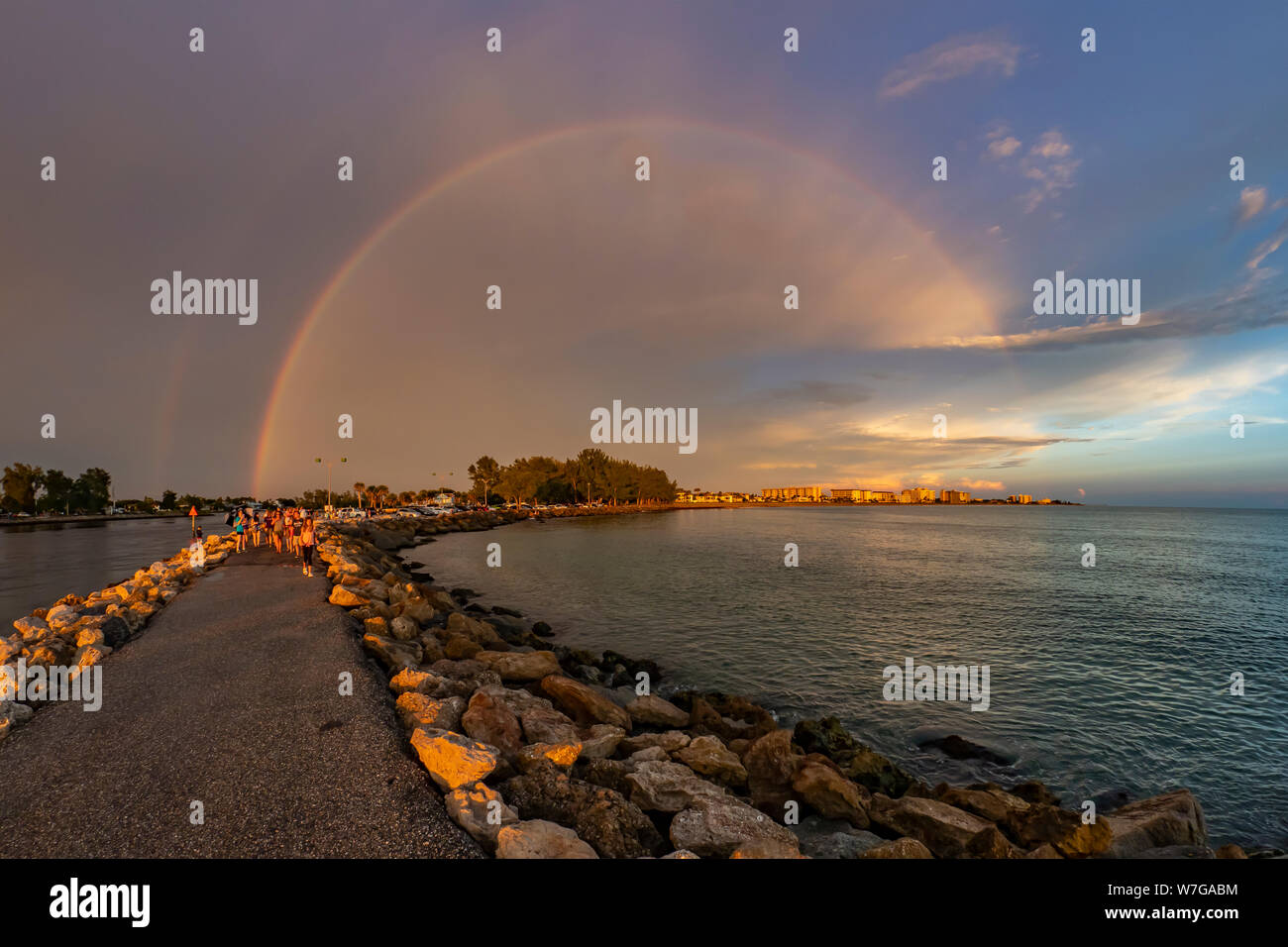 Full rainbow over Gulf of Mexico shore  at the South Jetty in Venice Florida Stock Photo