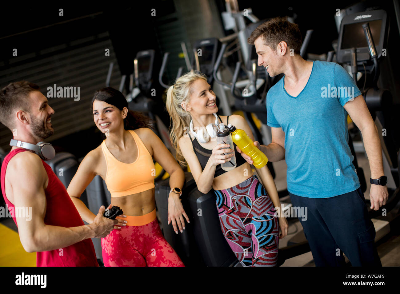 Group of sporty young people standing at the gym Stock Photo - Alamy