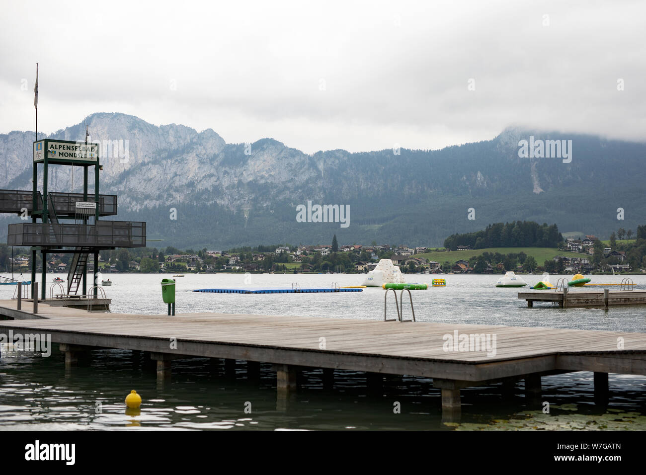 The dock with diving platform and swimming area at Alpenseebad in Mondsee, Austria, in the Alps on Mondsee lake. Stock Photo