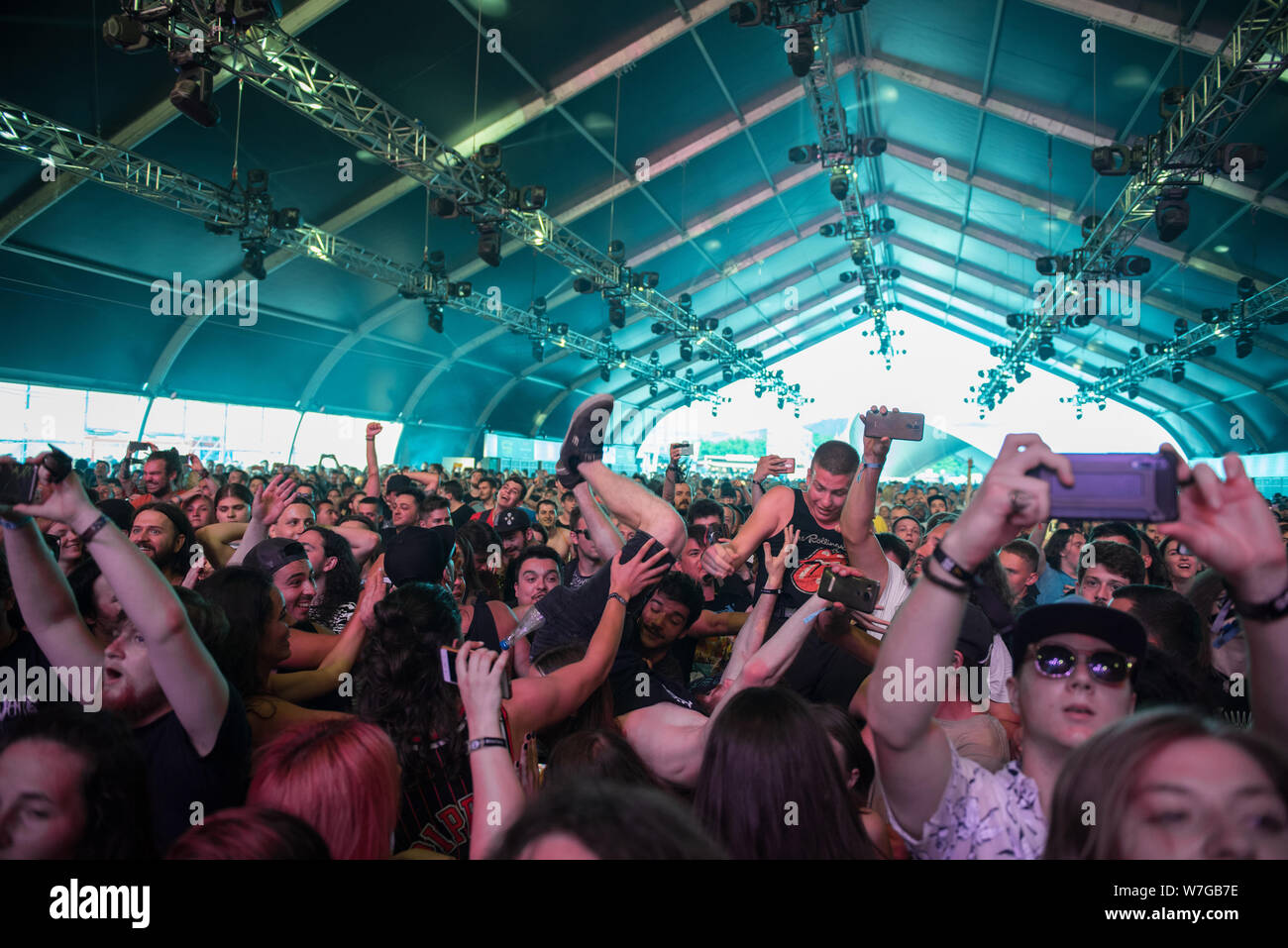 BONTIDA, ROMANIA - JULY 20, 2019: Rocker guy doing crowd-surfing during a While She Sleeps rock concert at Electric Castle festival Stock Photo