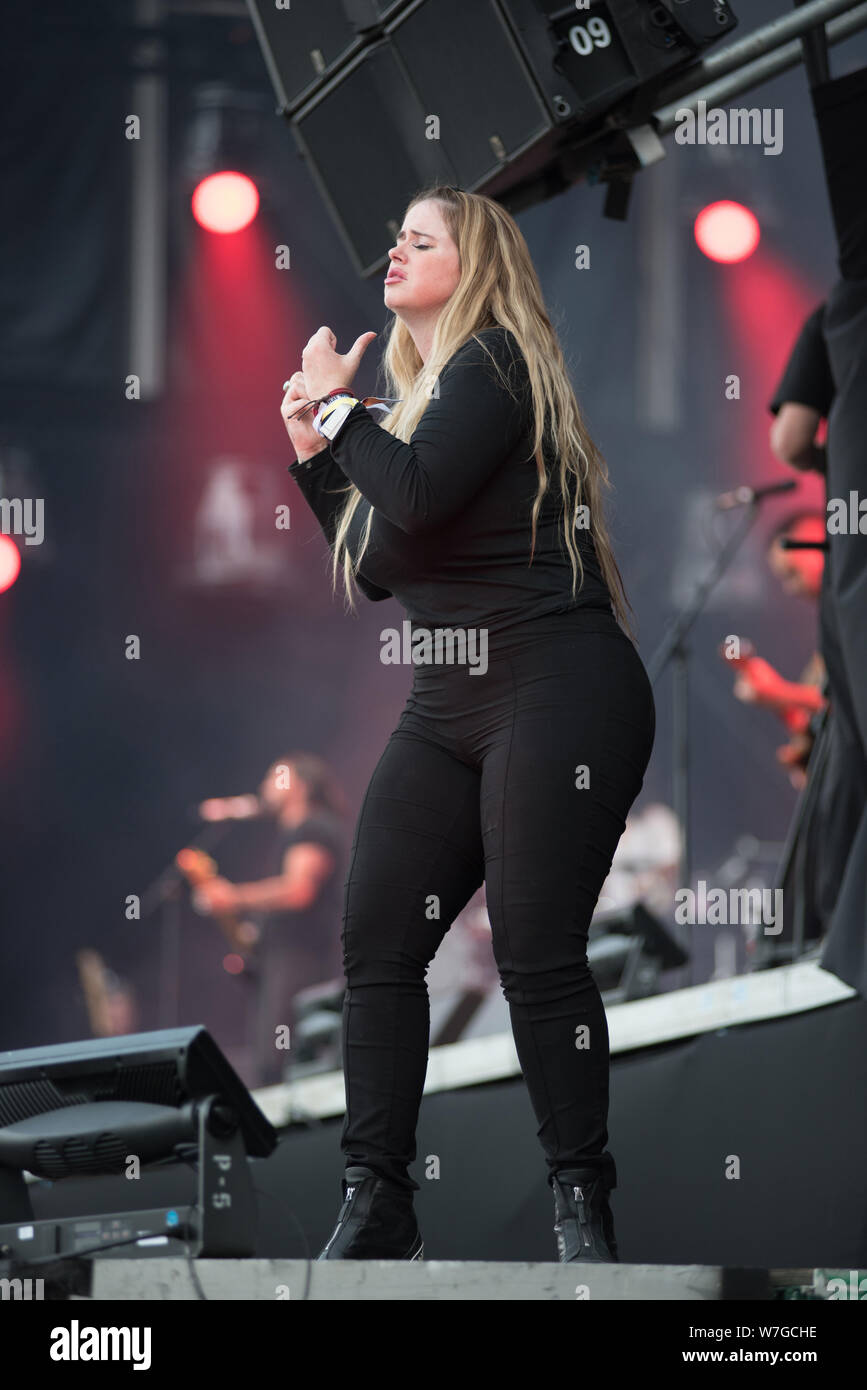 BONTIDA, ROMANIA - JULY 18, 2019: Sign language interpreter translating a song for persons with hearing impediment at Electric Castle festival Stock Photo
