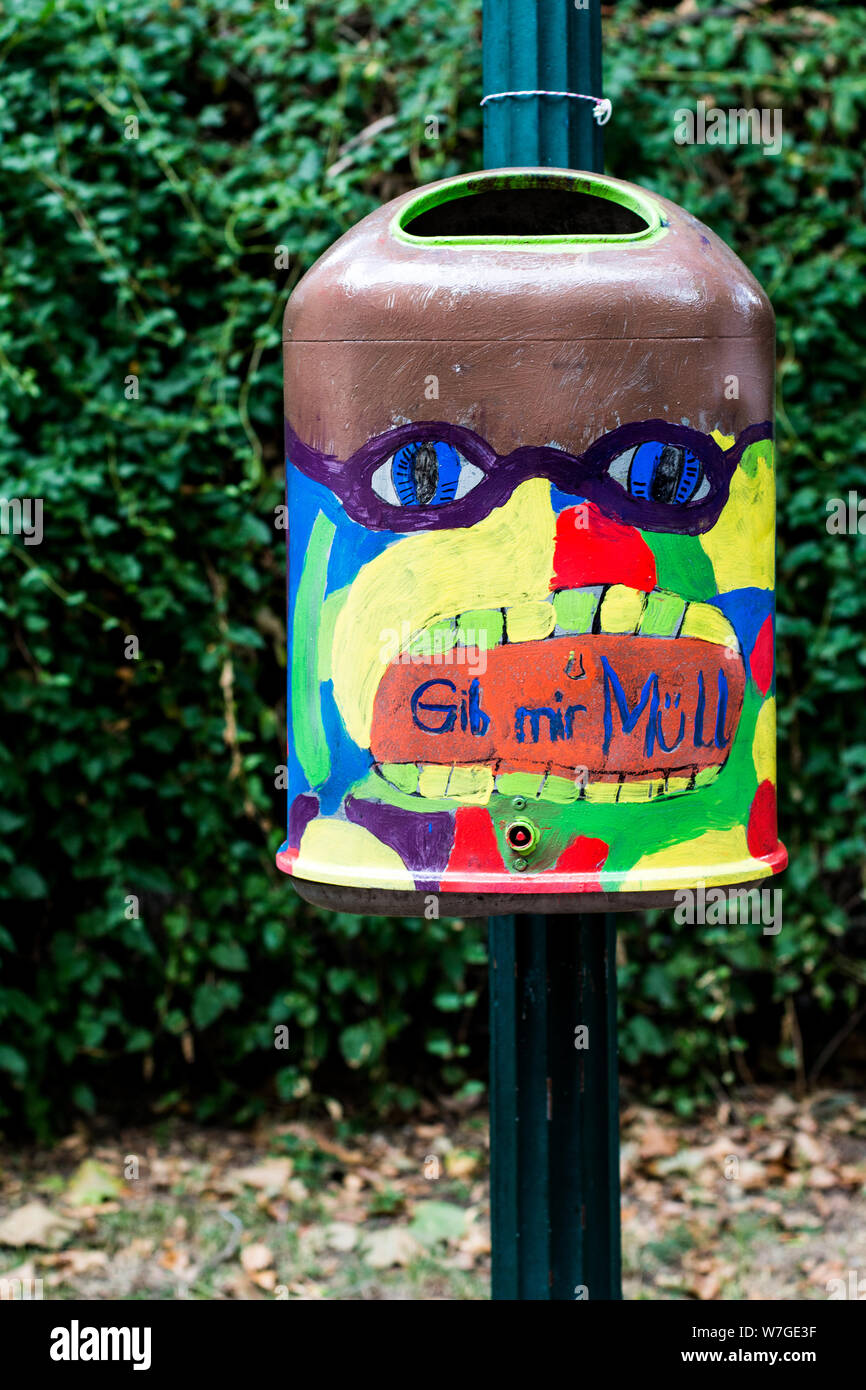 Closeup of painted trashcan spelling 'Gib Mir Muell' which can be translated to 'give me trash' in downtown Hannover, Germany Stock Photo
