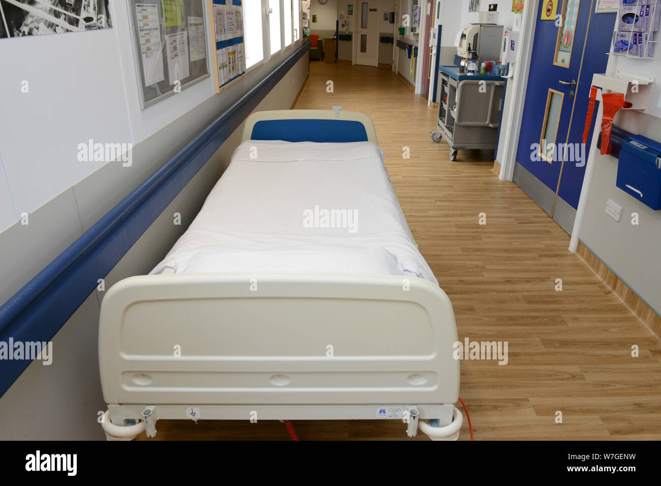 NHS hospital bed in a corridor. Stock Photo