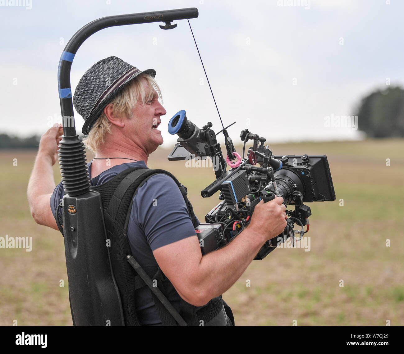 Reichenow, Germany. 06th Aug, 2019. Director Detlev Buck stands with a film  camera at the press event on the set of the Amazon series Bibi and Tina.  The shooting of the new