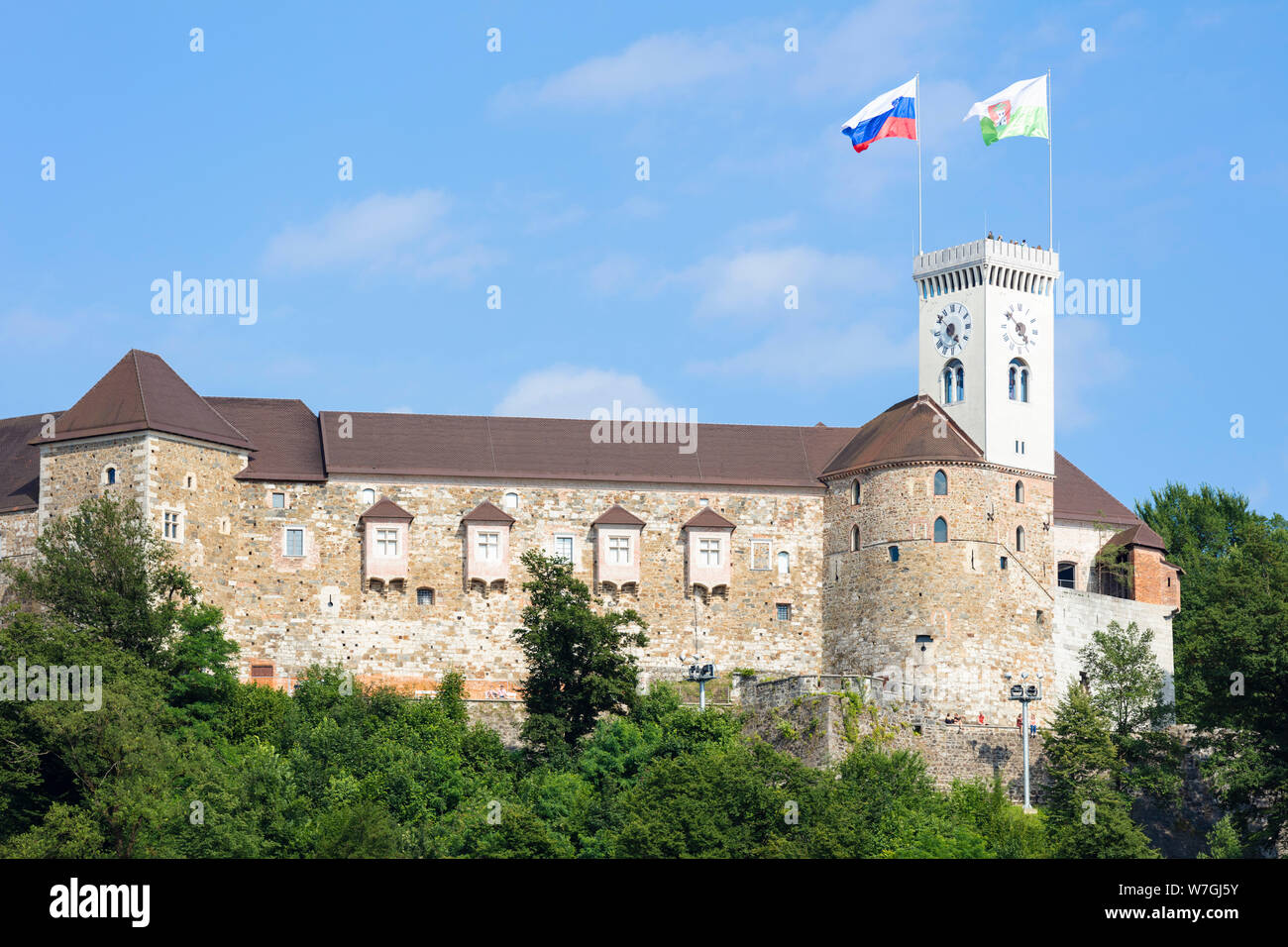 Castle of ljubljana castle with slovenian flag flying on Castle Hill Old Town Ljubljana Slovenia EU Europe Stock Photo