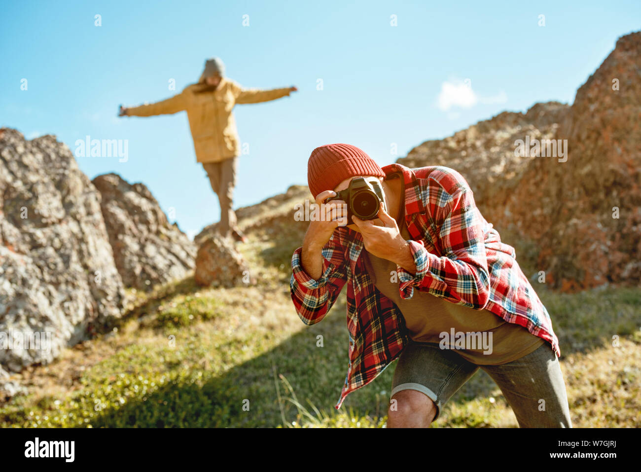 Happy couple is walking and photographing outdoors. Lifestyle photo Stock Photo