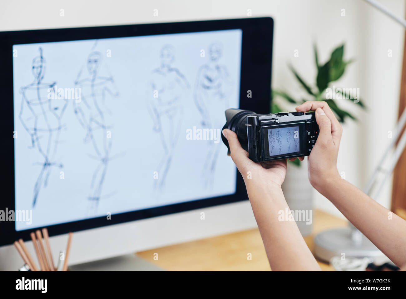 Fashion designer or blogger photographing computer screen with line ...