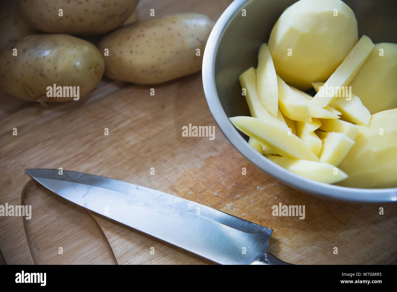 Fresh raw potato stick prepared for cooking in the kitchen - potato cooking concept Stock Photo