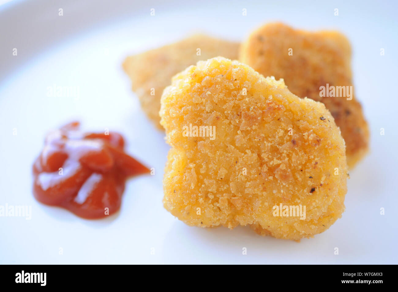 chicken nugget and ketchup on dish Stock Photo Alamy