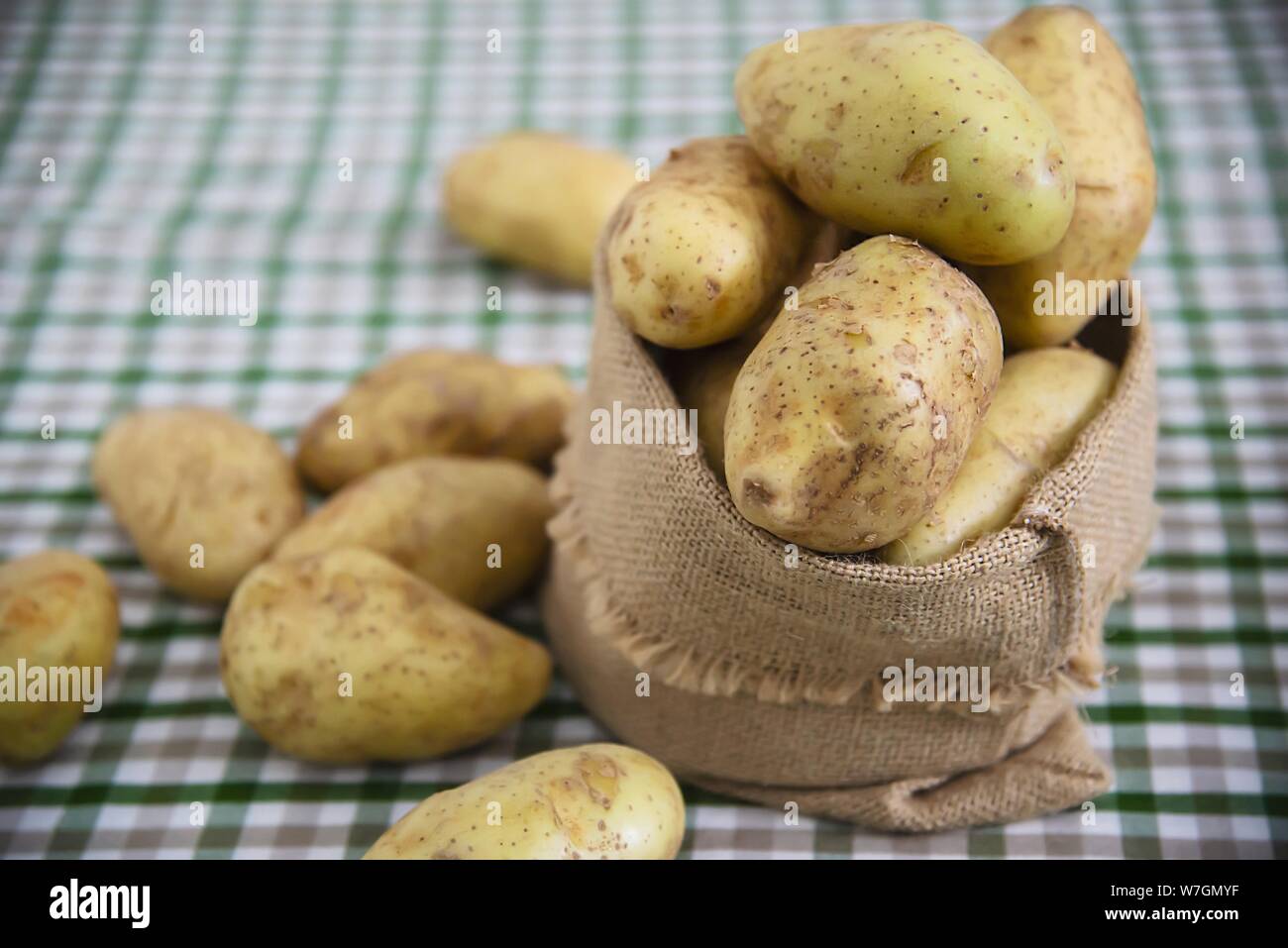 Fresh potato in kitchen ready to be cooked - fresh vegetable preparing for making food concept Stock Photo