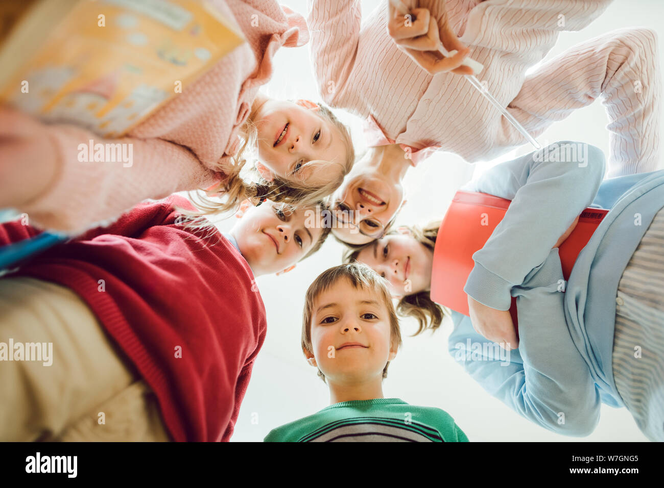 Schoolchildren and teacher looking down at the camera Stock Photo