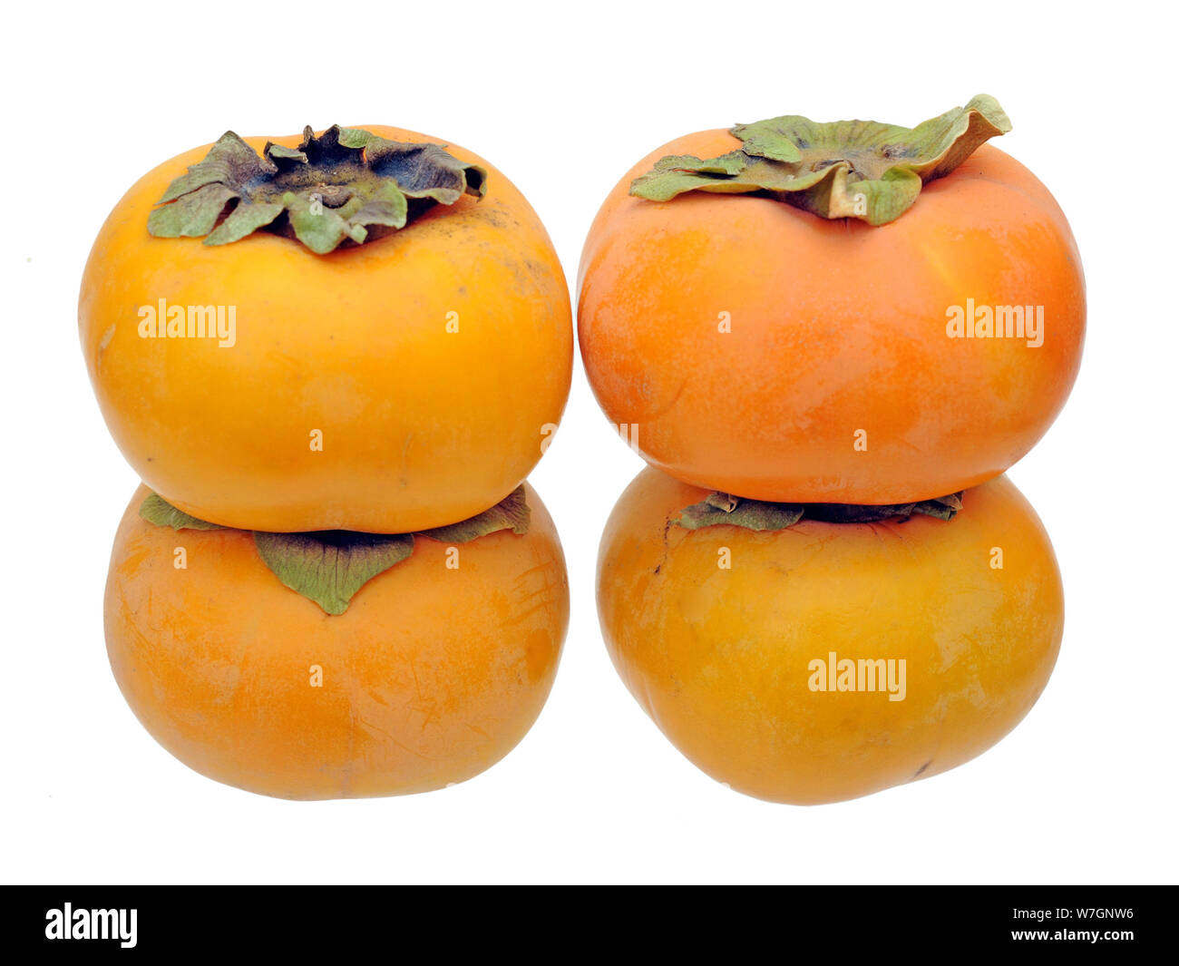 Persimin Ripe four ripe persimmon isolated on white background Stock Photo - Alamy