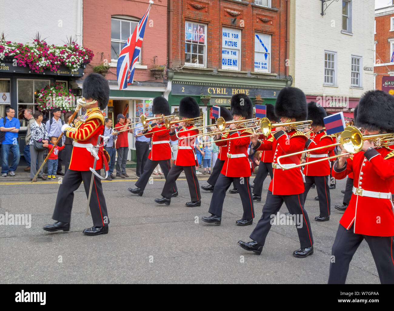 Soldiers of the Household Troops march through the town centre during the changing the Castle Guard ceremony, Windsor, Berkshire, UK Stock Photo
