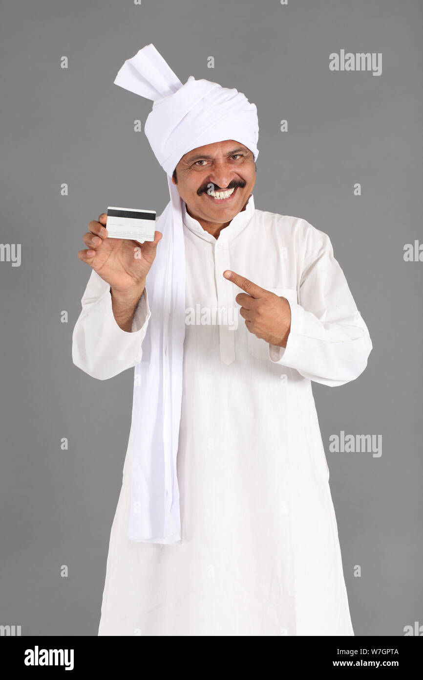 Rural man showing credit card and smiling Stock Photo - Alamy
