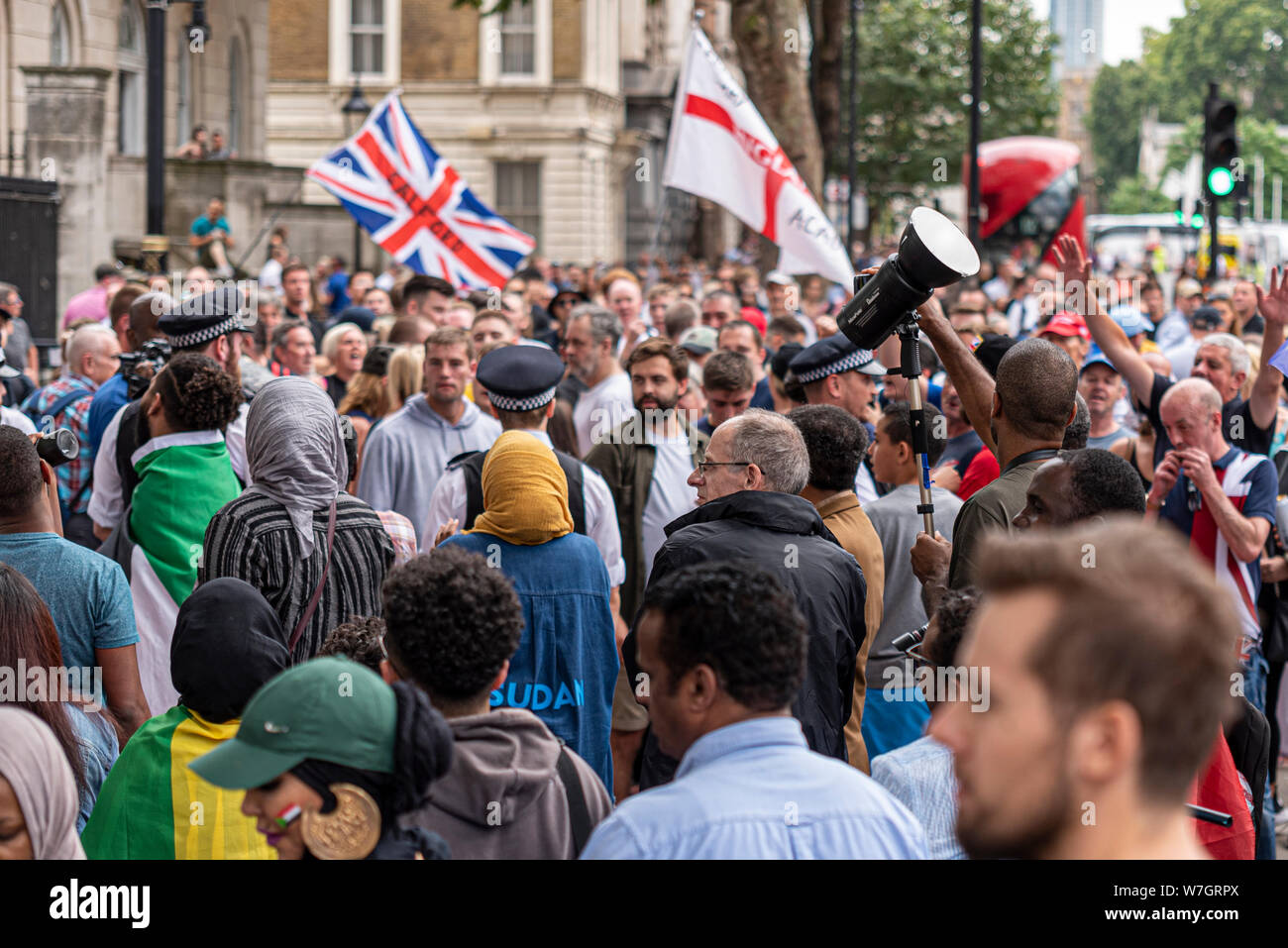 Free Tommy Robinson protest rally In London, UK, confronting British Socialists Support the Sudanese Revolution protest in Whitehall. Confrontational Stock Photo