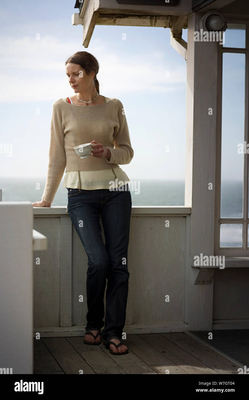 Woman standing in front of sea hi-res stock photography and images - Alamy