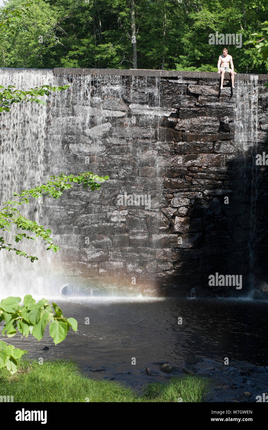 Water spills over dam at Puffer Pond in Amherst, Massachusetts Stock Photo