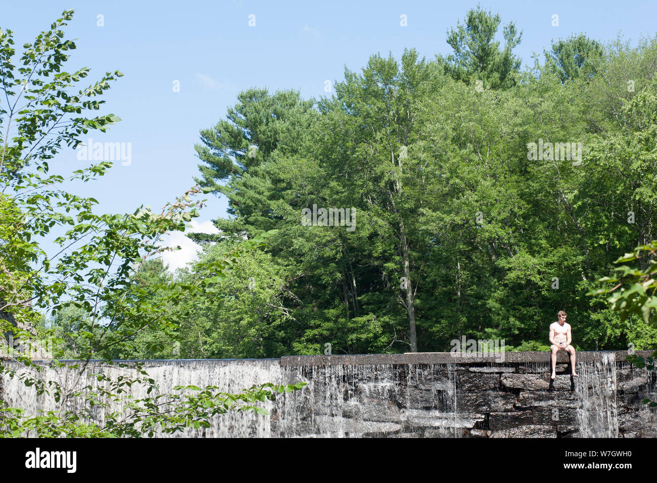 Water spills over dam at Puffer Pond in Amherst, Massachusetts Stock Photo