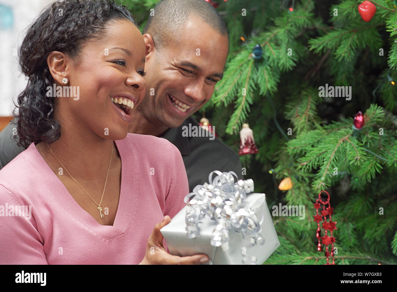 Couple opening gifts on Christmas Stock Photo