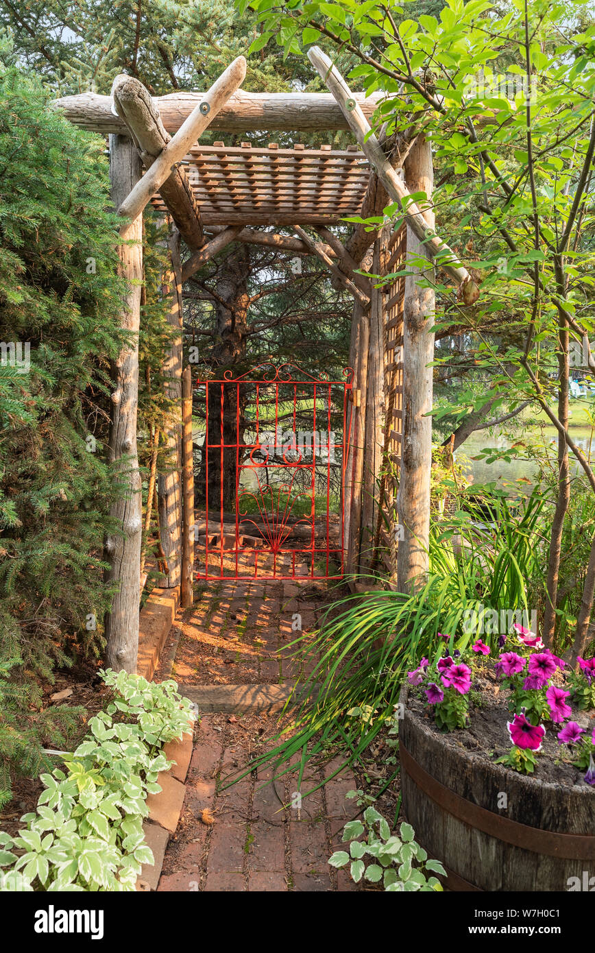 Orange Garden Gate in a Pergola at Canmore, Alberta, Canada Stock Photo