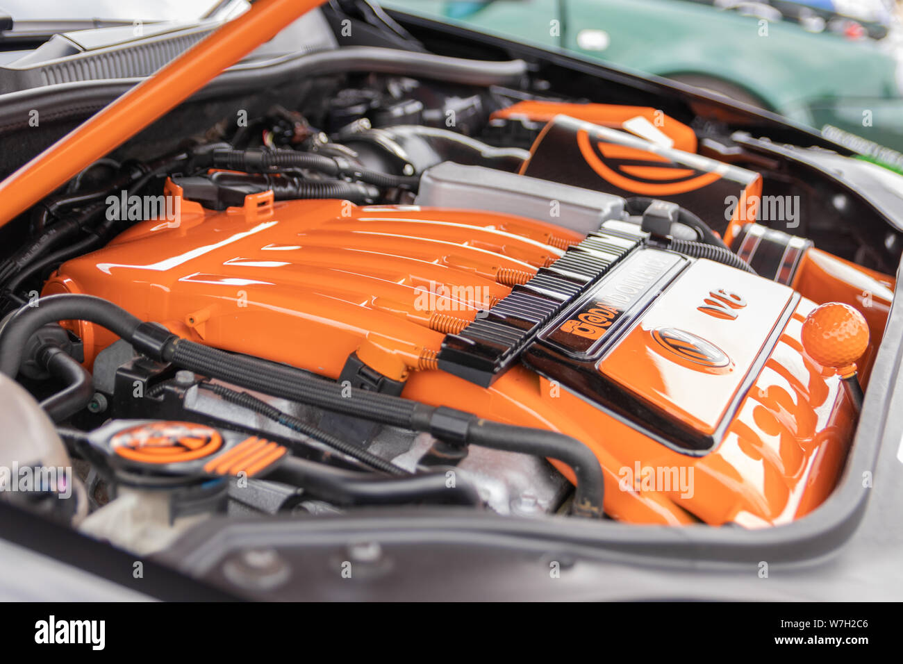 A close up of an orange Volkswagen or VW motor car engine which has been tuned up Stock Photo