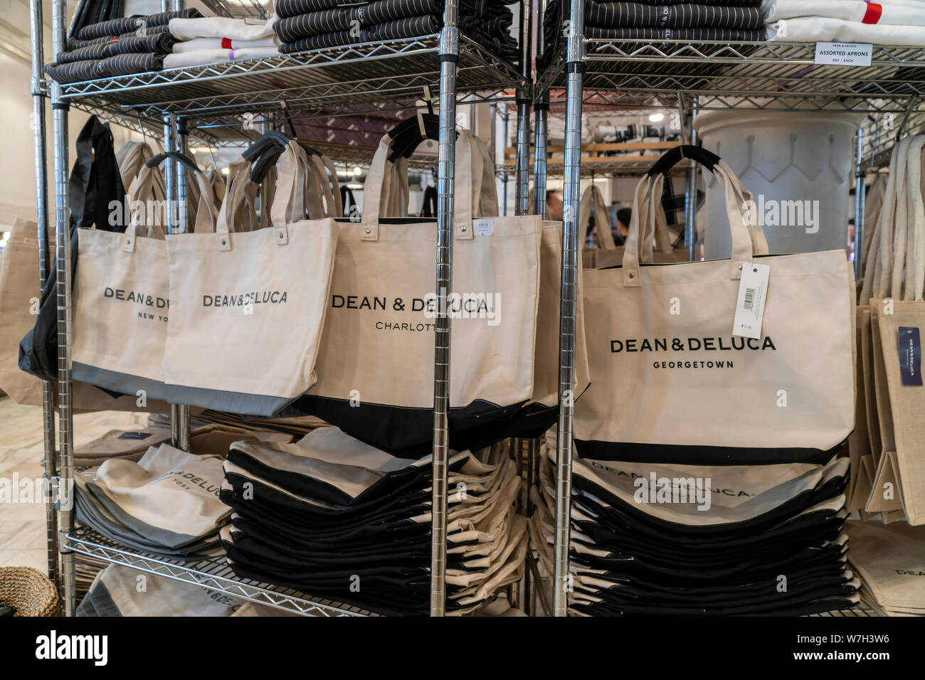 Tote bags branded with the locations of Dean & DeLuca stores in the Soho store in New York on Saturday, August 3, 2019. Facing competition from a myriad of other sources the trail-blazing Dean & DeLuca has amassed a number of unpaid bills and is not being supplied by some of its vendors. (© Richard B. Levine) Stock Photo