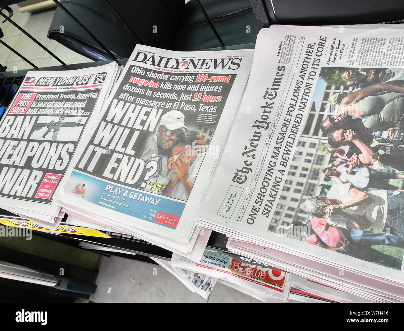 Front pages of New York newspapers on Monday, August 5, 2019 report on the previous weekends’ mass shootings in El Paso, TX and in Dayton, OH. (© Richard B. Levine) Stock Photo