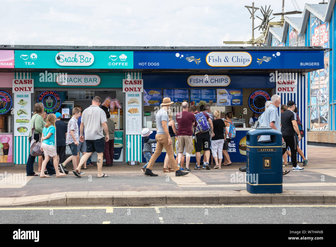 People queue for food at a seaside kiosk or fish and chips stall Stock Photo