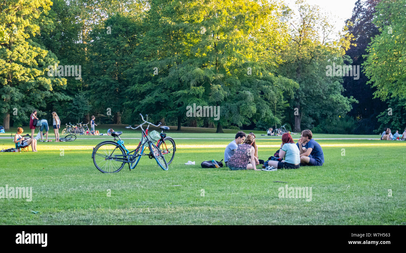Rotterdam, Netherlands. June 29, 2019. People resting on the grass in a summer afternoon, city park background Stock Photo