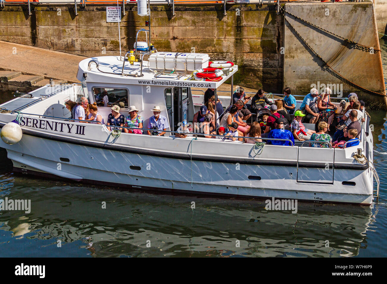 Tourists on board Serenity 3, a boat trip to the Farne Islands operating  from the harbour at Seahouses, Northumberland, UK. July 2019 Stock Photo -  Alamy