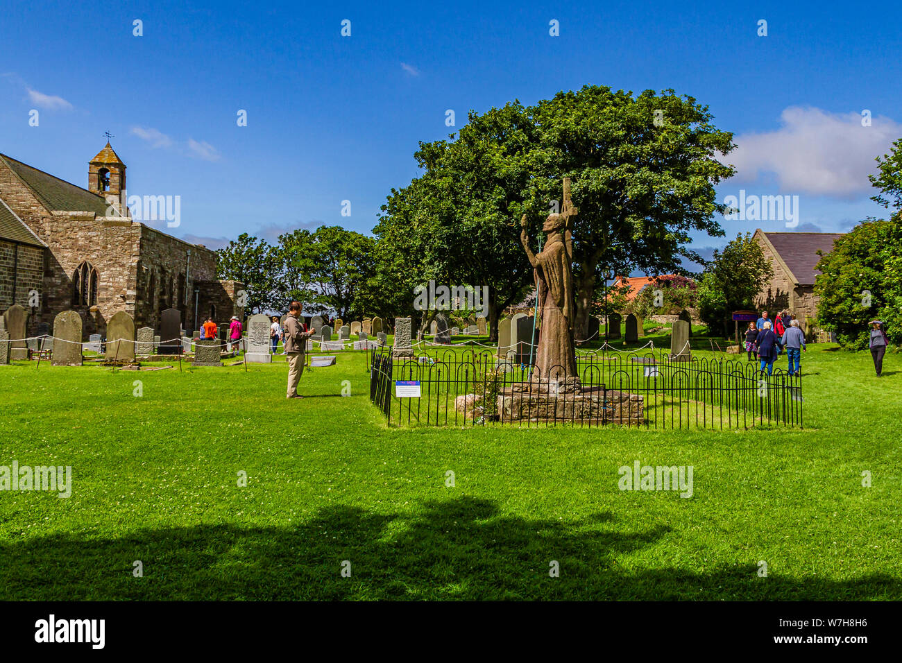 Statue of the medieval Saint Aidan in the grounds of Lindisfarne Priory. Holy Island of Lindisfarne, Northumberland, UK. July 2019. Stock Photo