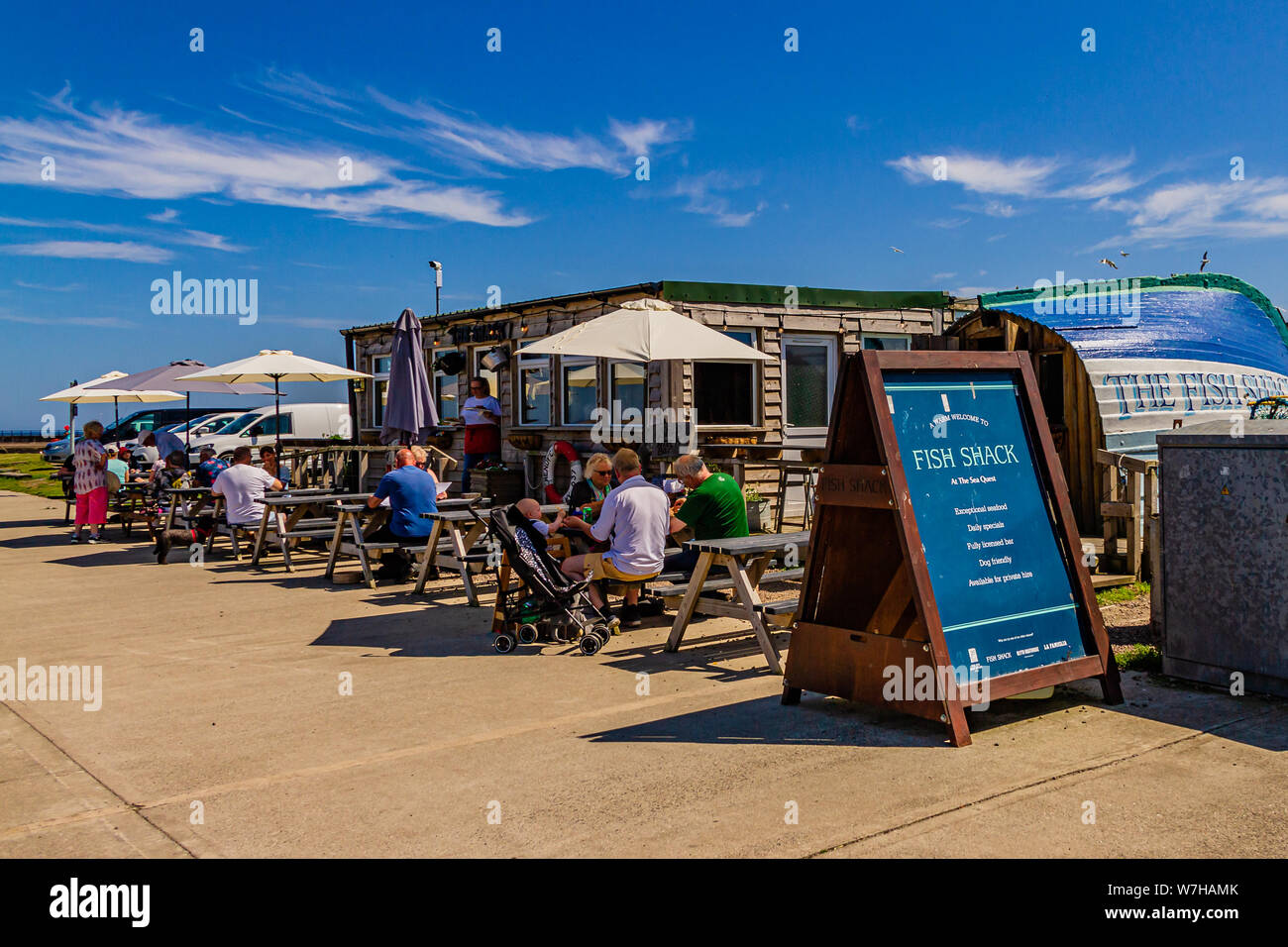The Fish Shack, a seafood restaurant partly inside an old upturned boat, by the harbour in Amble, Northumberland, UK. July 2019. Stock Photo