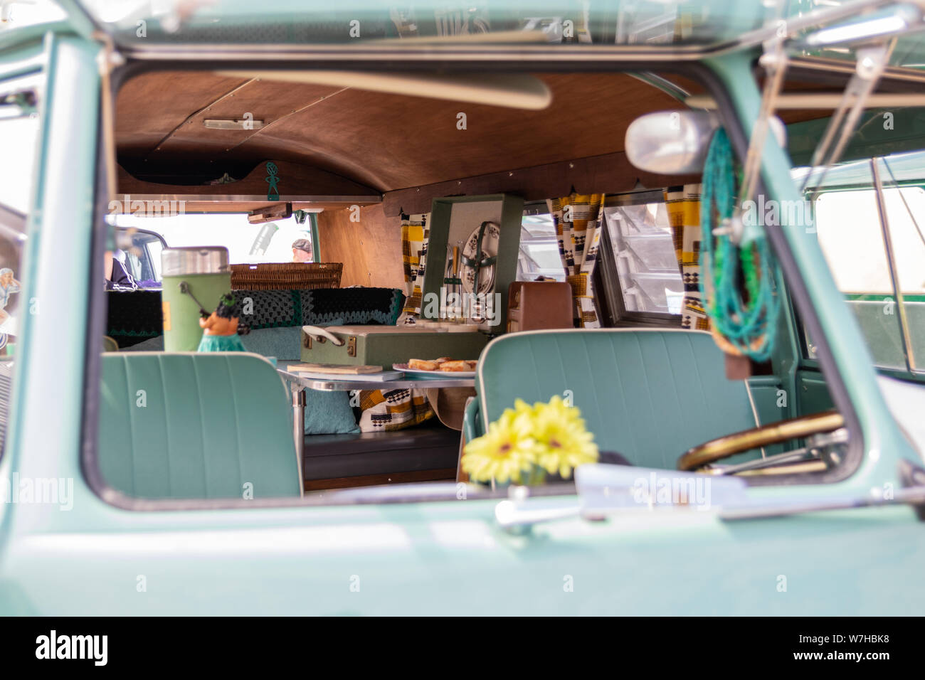 The interior of a vintage camper van with a vintage picnic basket Stock Photo